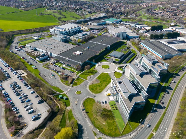 Aerial view of White Rose Park showing office buildings, parking lots, roads, and green spaces surrounded by residential areas.