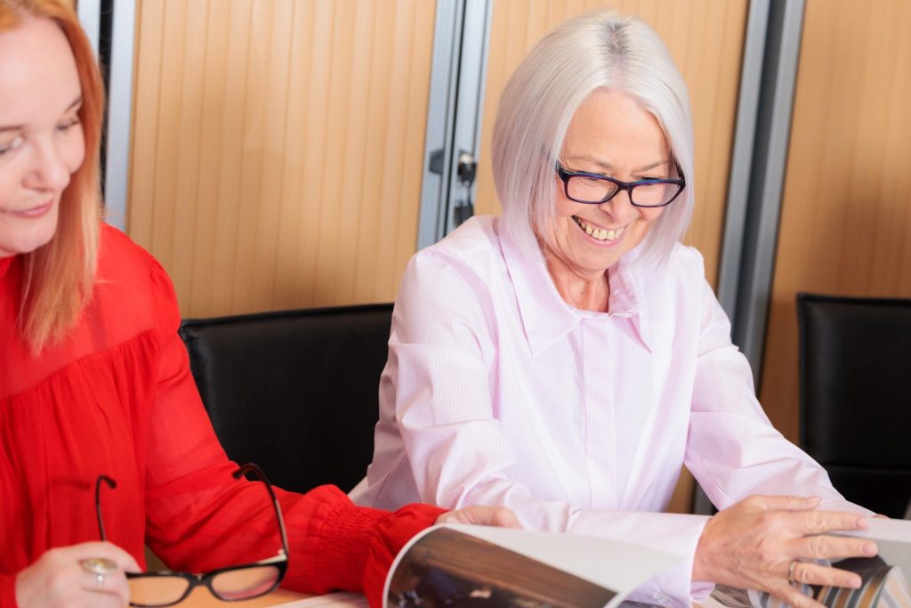 Two colleagues reviewing documents together at a meeting table